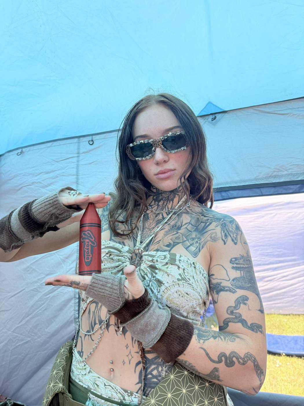 A festivalgoer holding a red Krayon